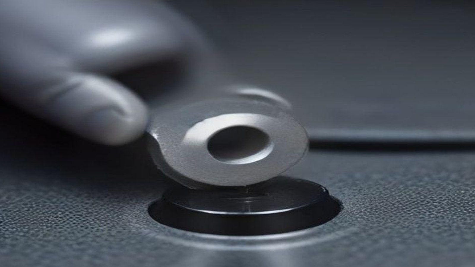 Close-up of a robot gripper attempting a precision insertion